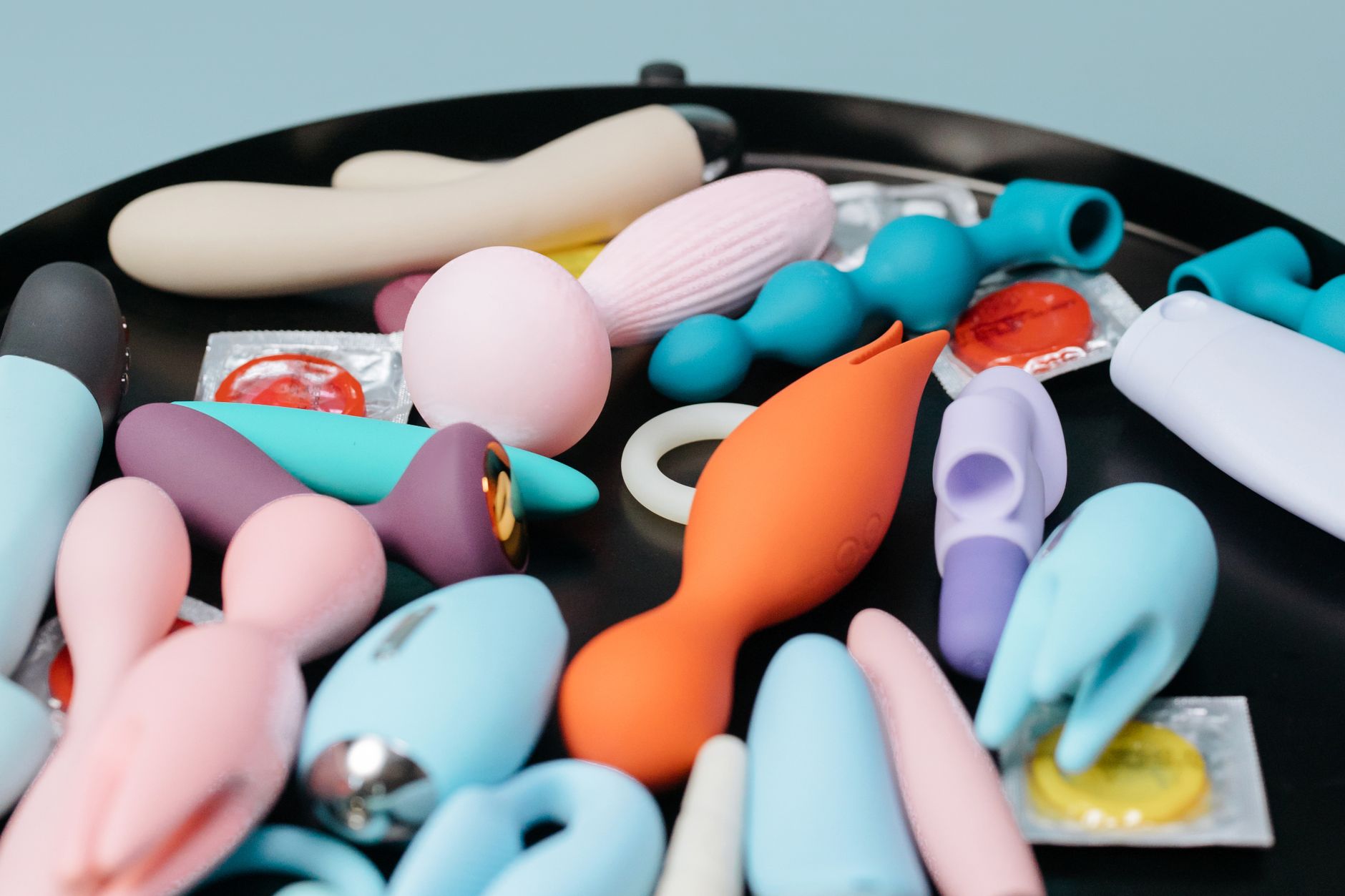 A collection of colorful vibrators and adult toys on display, representing intimacy and exploration.