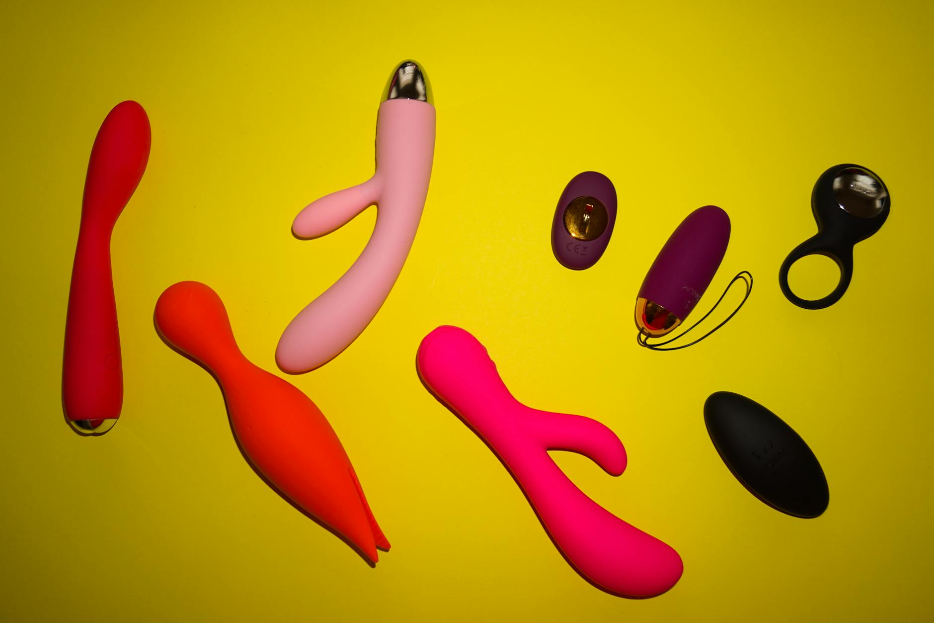 A yellow silicone vibrator surrounded by peeled bananas on a bright yellow background, symbolizing renewed pleasure
