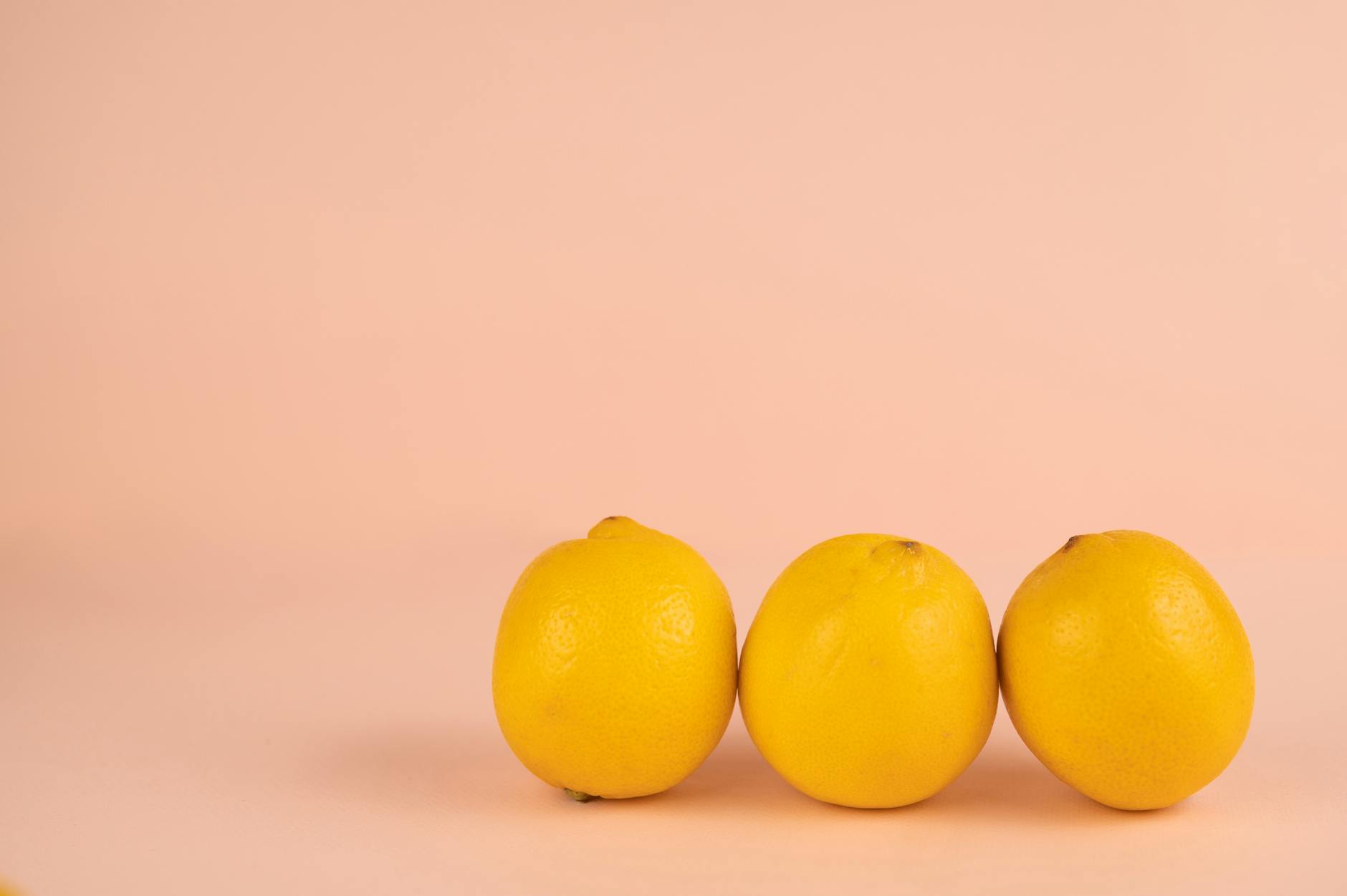 Bright ripe lemons arranged on a pastel background, symbolizing natural rhythm and cycles